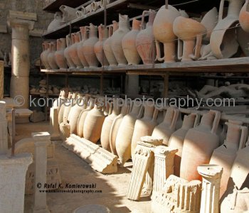 A row of upright ancient vases in Pompeii