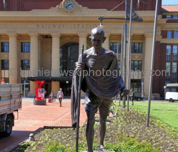 A life-size bronze statue of Mahatma Gandhi at the front lawn of the Railway Station on Bunny Street, Wellington, New Zealand