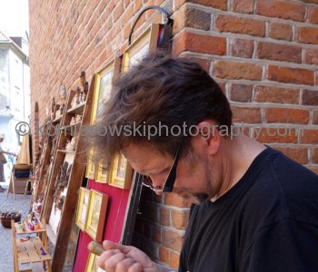 Local artist at work in Stare Miasto-the restored Old Town section, Warsaw, Poland
