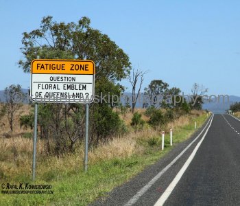 ...a road sign on Bruce Highway warns drowsy drivers to play trivia to stay awake on long stretches....