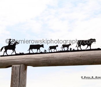 Steel silhouette entrance gate as seen from the Cowboy Trail near Priddis